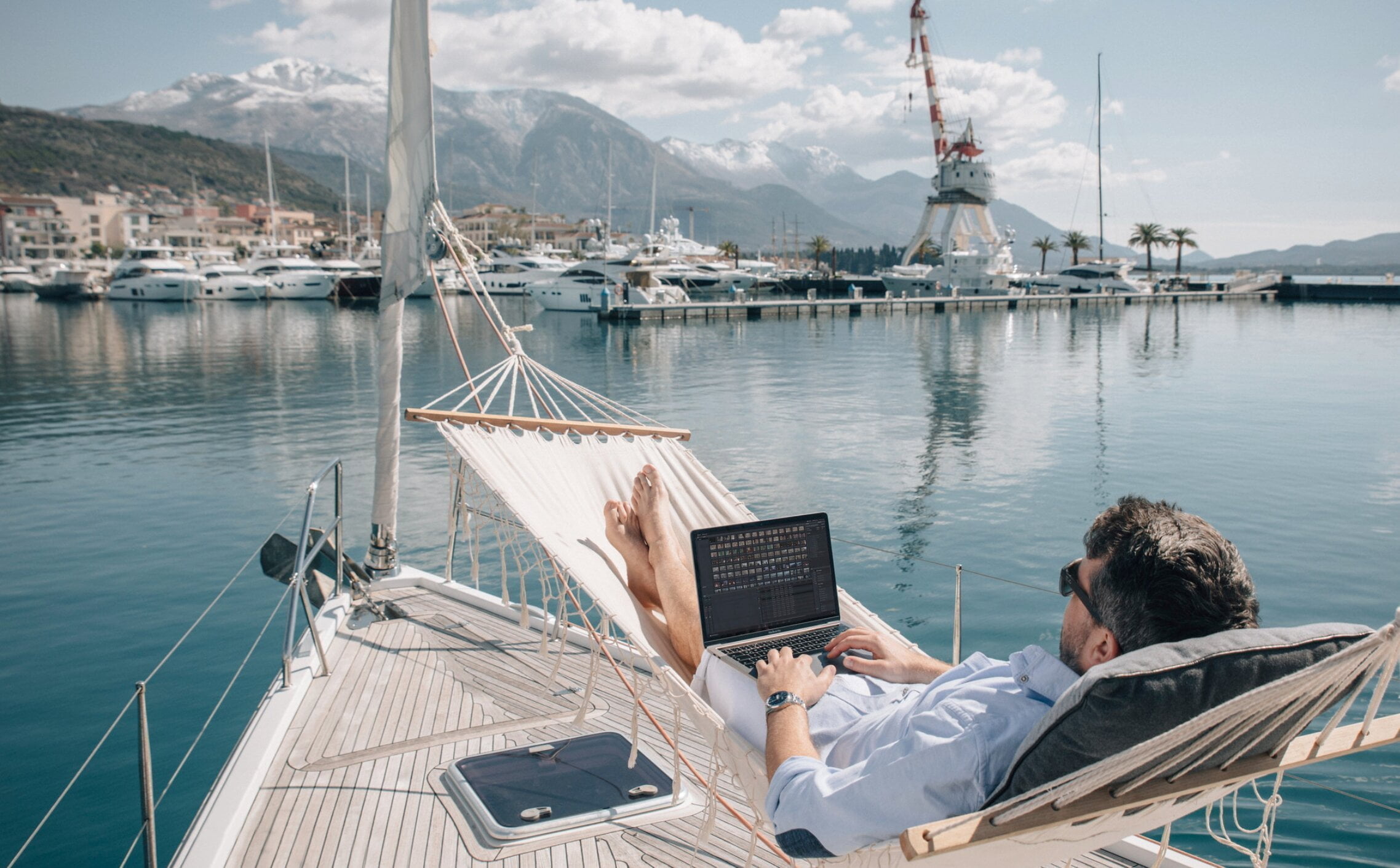 Man on laptop near the sea