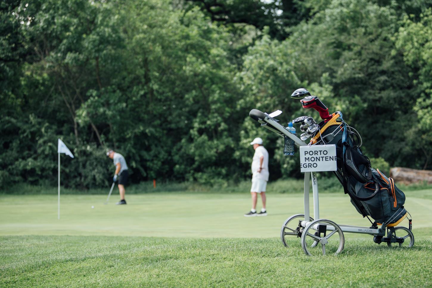 Golf field wit players and bag