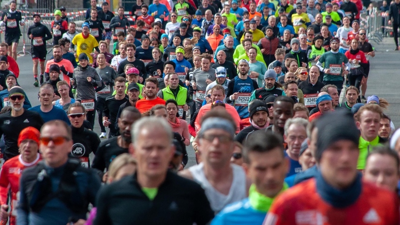 Runners participating in a marathon in Montenegro, wearing race bibs and athletic gear.